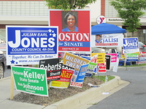 Election campaign signs on display in street.