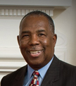 Smiling man in a suit and tie.