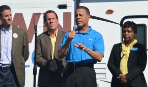 Group of people speaking at outdoor event.