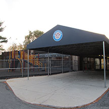 School entrance canopy and playground equipment.
