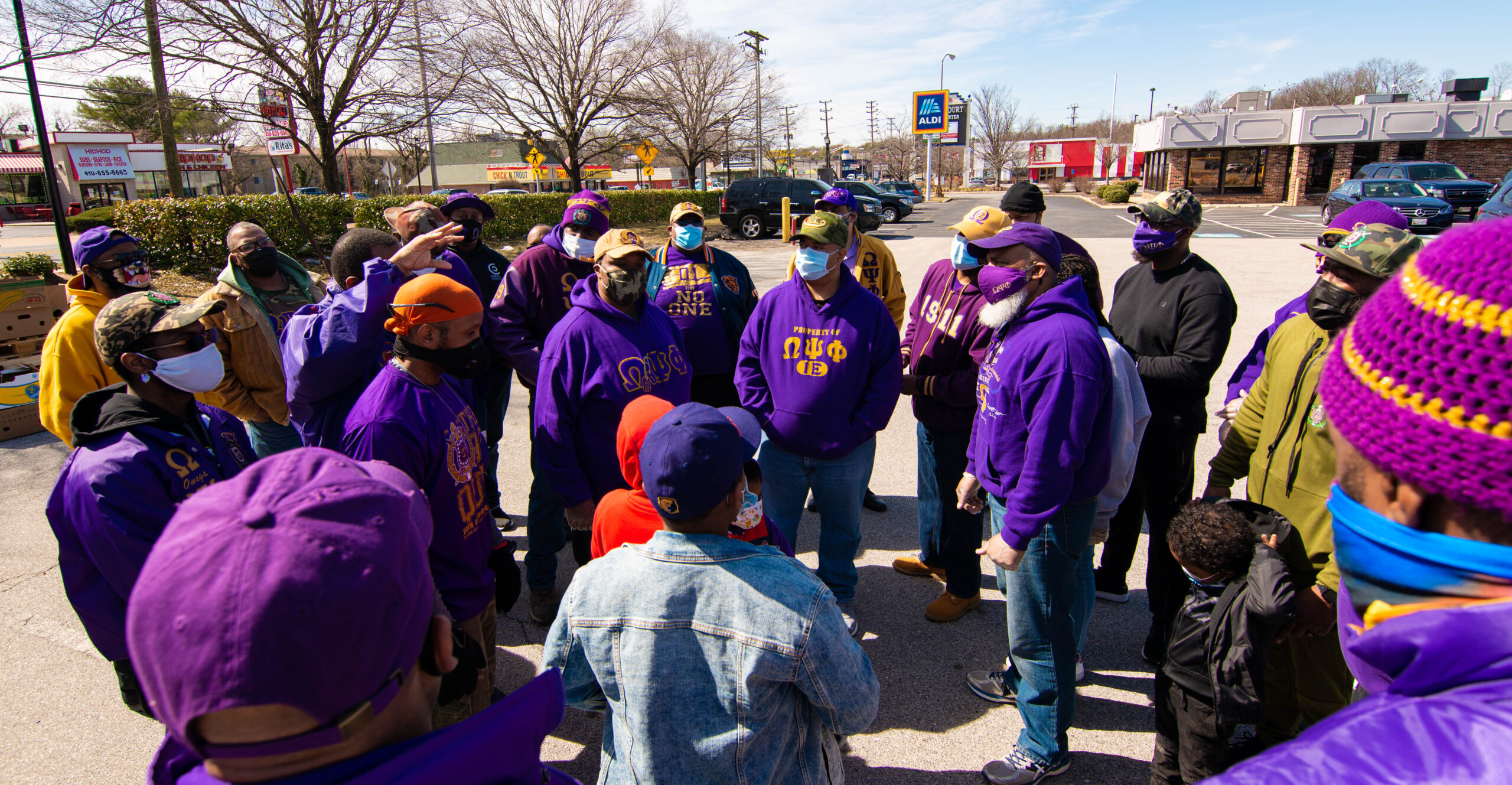 A group of people in colorful winter hats gathered outdoors.