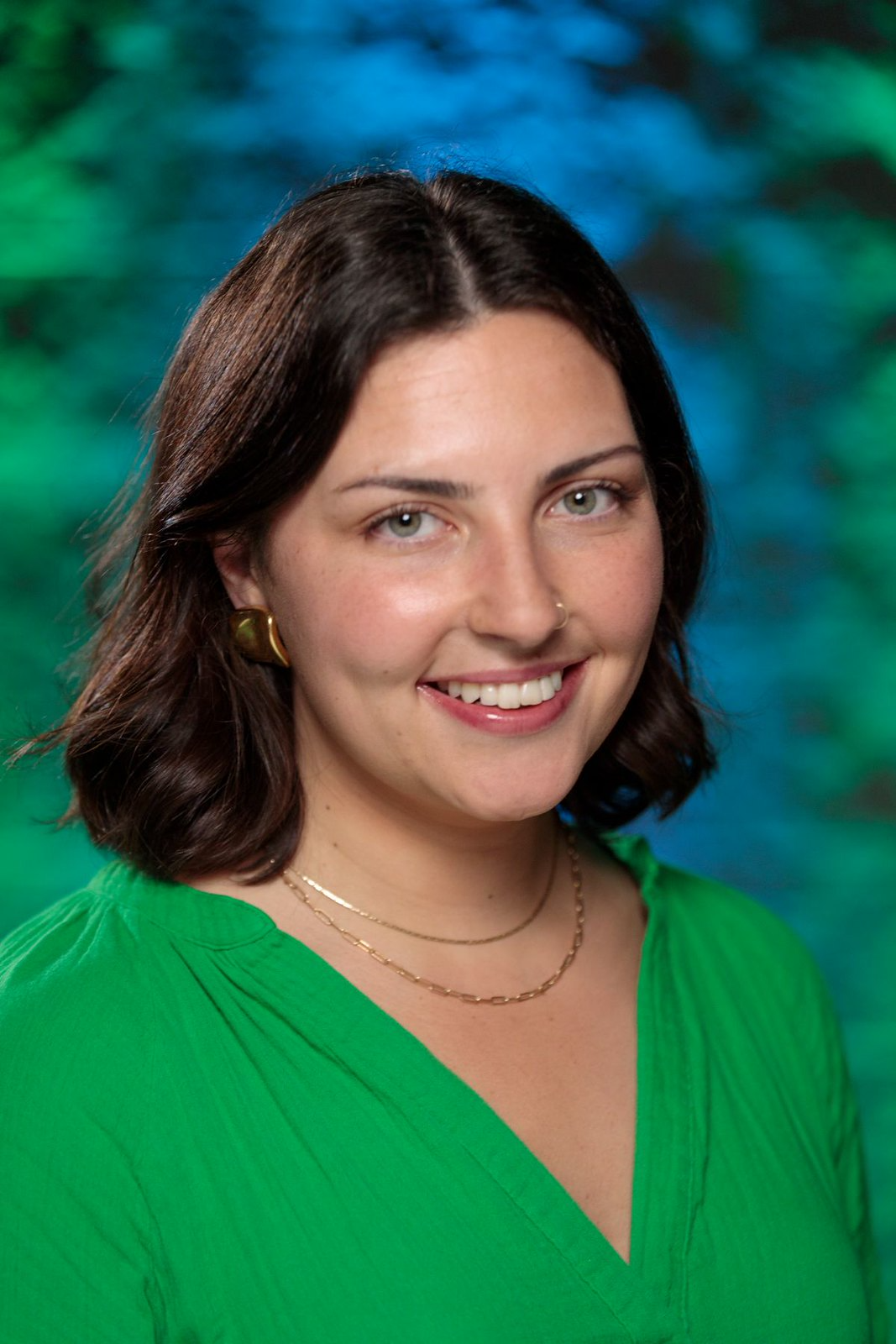 Family reunion group holding hands in a prayer circle outdoors.